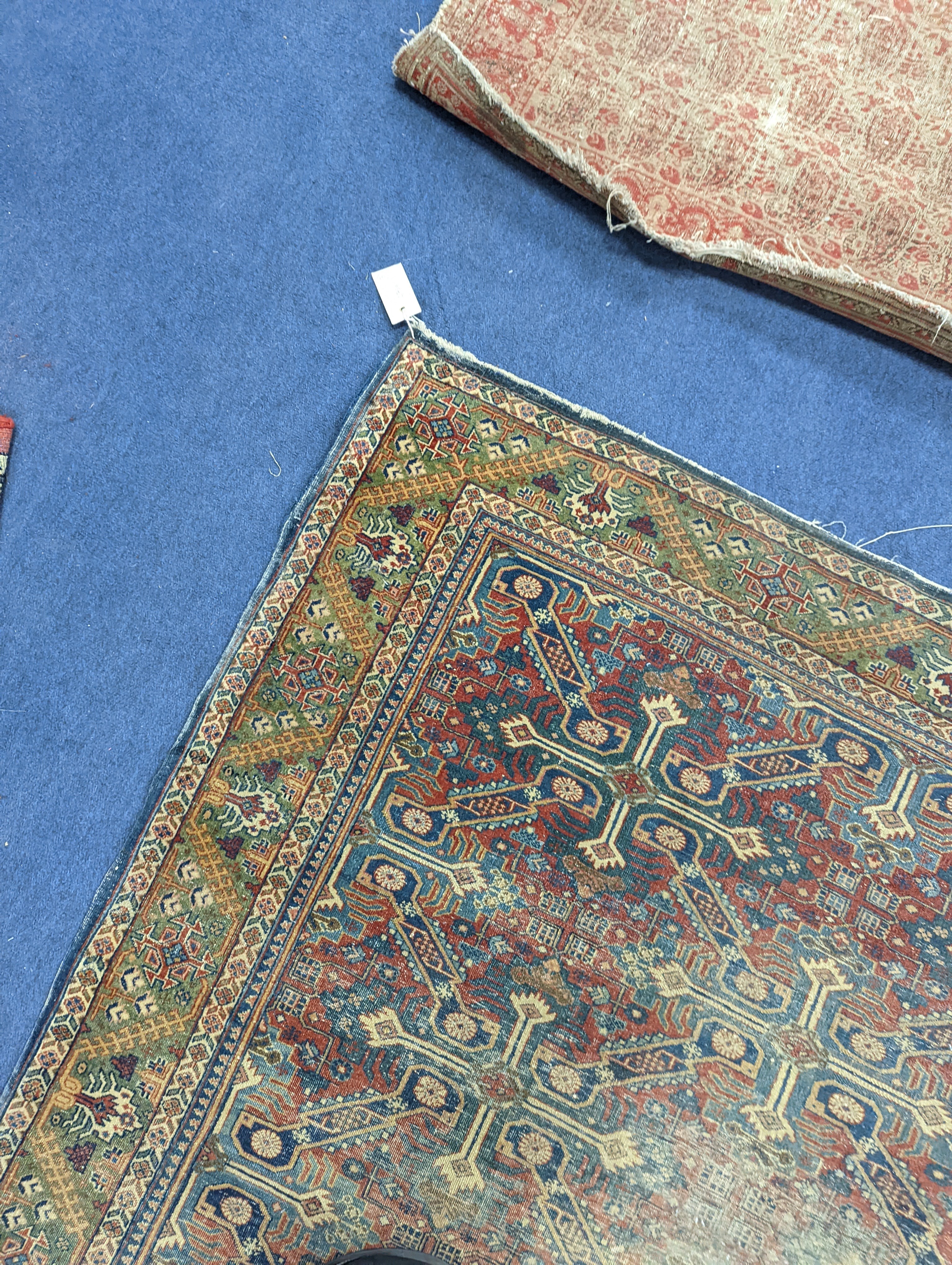 Three antique rugs, Caucasian and North West Persian, largest 230 x 154cm